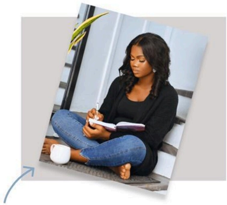 Woman sitting on steps writing in a notebook, planning for the Goal Setting Masterclass